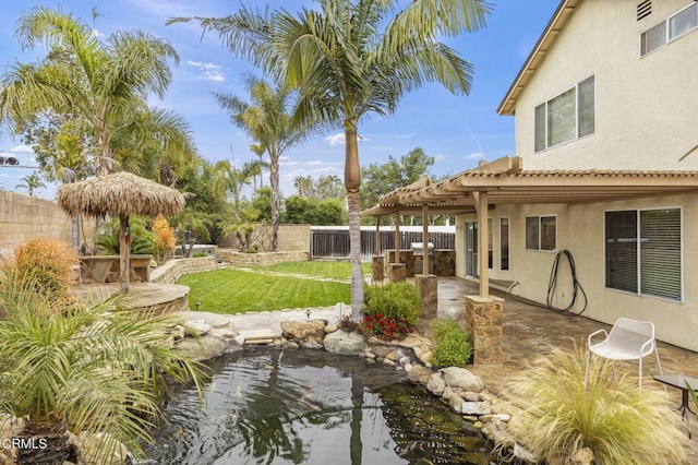 view of yard featuring a garden pond, a pergola, a fenced backyard, and a patio area