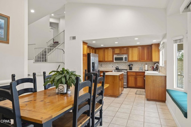 dining space with visible vents, high vaulted ceiling, recessed lighting, and light tile patterned floors