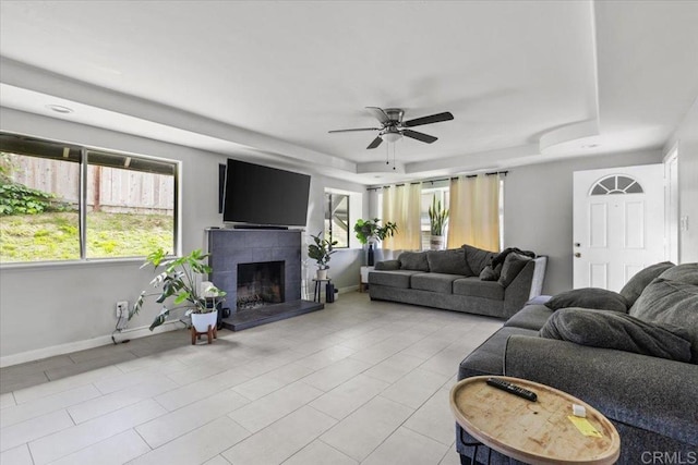 111 69th St, San Diego, CA 92114 - living area with a tray ceiling, ceiling fan, a fireplace, and plenty of natural light