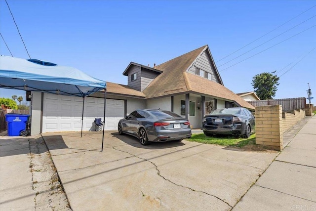 111 69th St, San Diego, CA 92114 - view of home's exterior with driveway, a garage, and roof with shingles