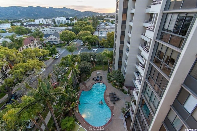345 Pioneer Dr Unit 1705, Glendale, CA 91203 - pool at dusk with a mountain view, a community pool, and a patio area