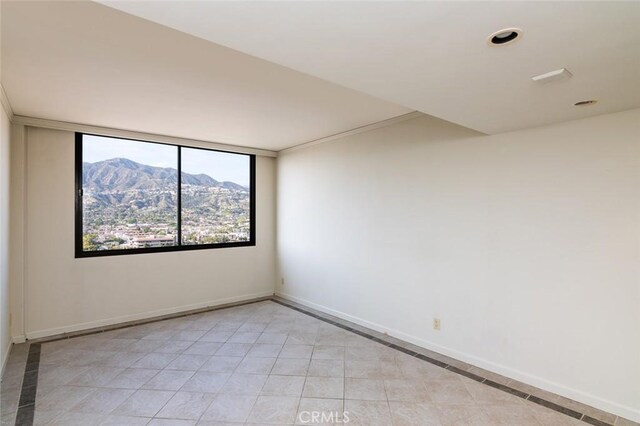 345 Pioneer Dr Unit 1705, Glendale, CA 91203 - empty room with a mountain view, light tile patterned floors, and baseboards