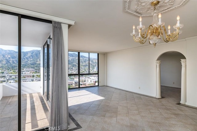 345 Pioneer Dr Unit 1705, Glendale, CA 91203 - spare room featuring floor to ceiling windows, arched walkways, a mountain view, and a chandelier