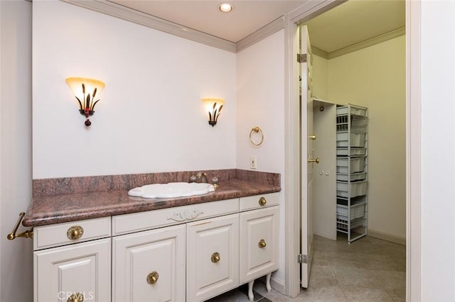 bathroom with tile patterned floors, baseboards, recessed lighting, crown molding, and vanity