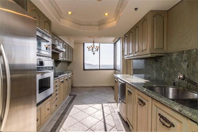 kitchen featuring recessed lighting, stainless steel appliances, an inviting chandelier, baseboards, and decorative backsplash