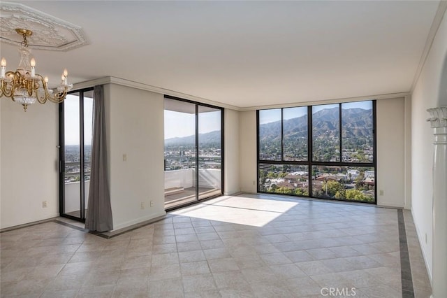 345 Pioneer Dr Unit 1705, Glendale, CA 91203 - unfurnished room with a mountain view, expansive windows, a chandelier, and tile patterned flooring