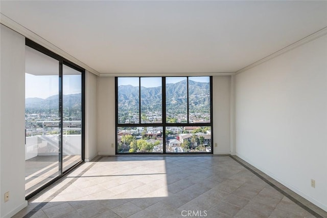 345 Pioneer Dr Unit 1705, Glendale, CA 91203 - spare room with floor to ceiling windows, a mountain view, crown molding, and baseboards