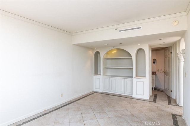 unfurnished room featuring baseboards, built in features, visible vents, ornamental molding, and light tile patterned floors