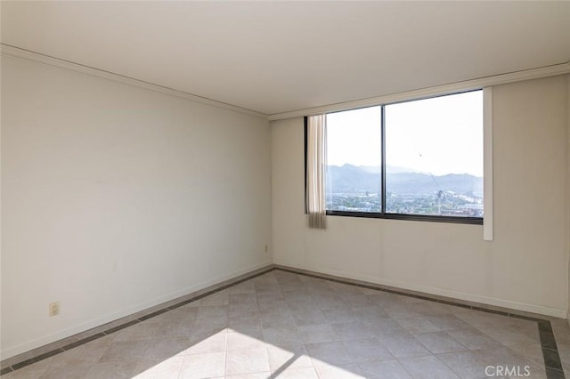 345 Pioneer Dr Unit 1705, Glendale, CA 91203 - empty room featuring inlaid floor details, baseboards, a mountain view, and light tile patterned floors
