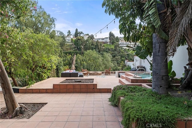 view of patio with an outdoor fire pit
