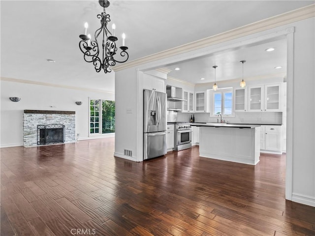 6608 Via Siena, Rancho Palos Verdes, CA 90275 - kitchen featuring stainless steel appliances, healthy amount of natural light, crown molding, wall chimney exhaust hood, and glass insert cabinets