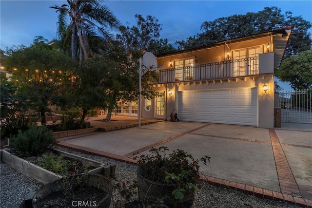 6608 Via Siena, Rancho Palos Verdes, CA 90275 - view of front of property featuring french doors, a balcony, concrete driveway, an attached garage, and stucco siding