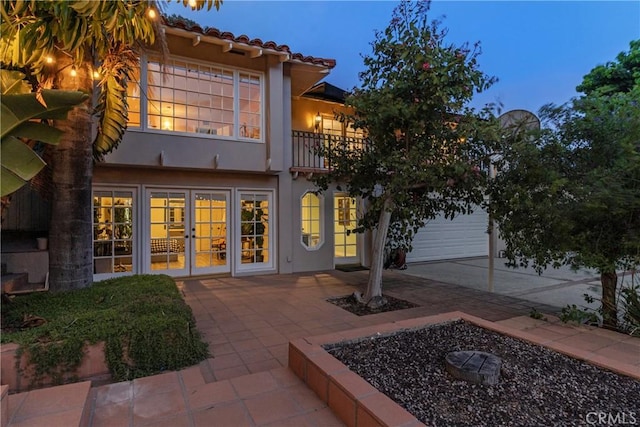6608 Via Siena, Rancho Palos Verdes, CA 90275 - back of house featuring french doors, stucco siding, a balcony, a garage, and a tile roof
