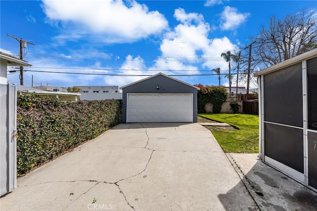 detached garage featuring fence