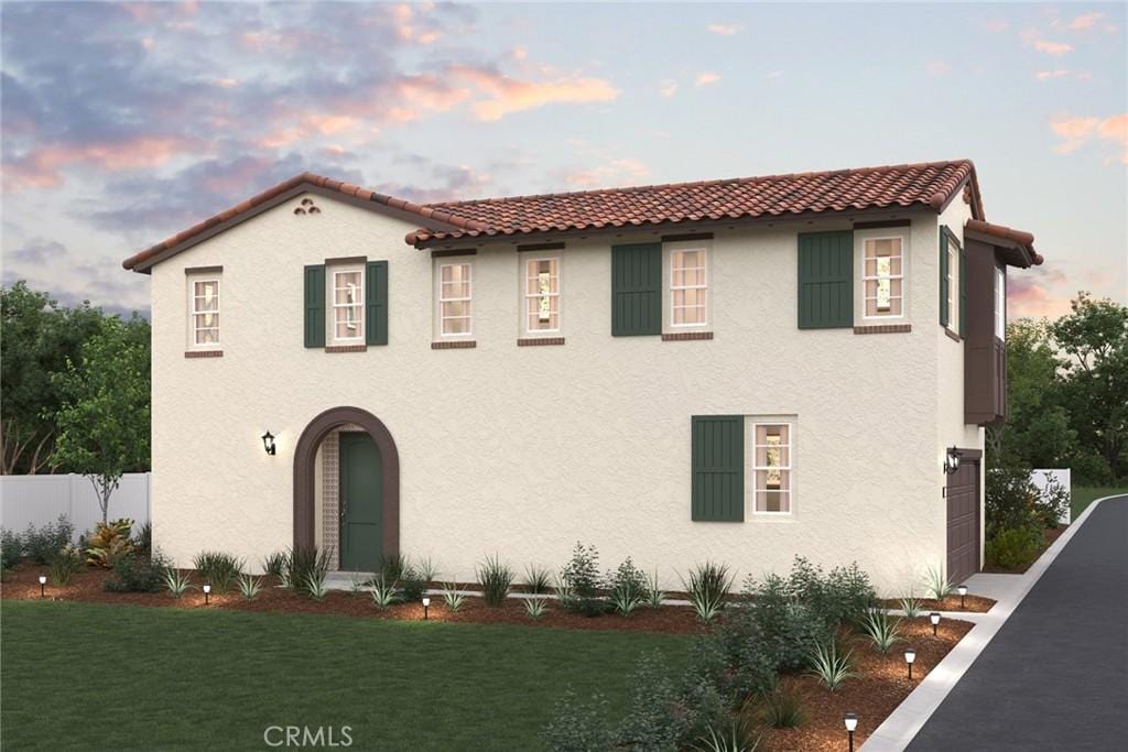 1414 Rue Ct, Upland, CA 91786 - mediterranean / spanish home featuring fence, a tiled roof, a front lawn, and stucco siding