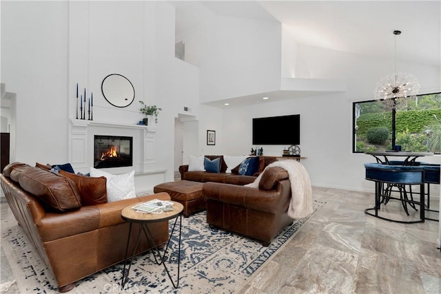 living room with a glass covered fireplace, high vaulted ceiling, and marble finish floor
