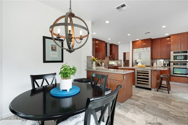 dining area with visible vents, recessed lighting, an inviting chandelier, and wine cooler