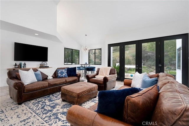 living area with high vaulted ceiling and french doors