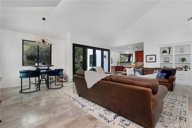 living area featuring high vaulted ceiling and a chandelier