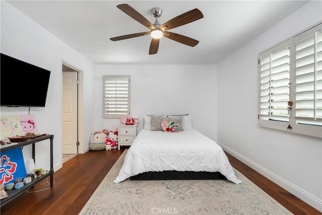 bedroom featuring wood finished floors, ceiling fan, and baseboards