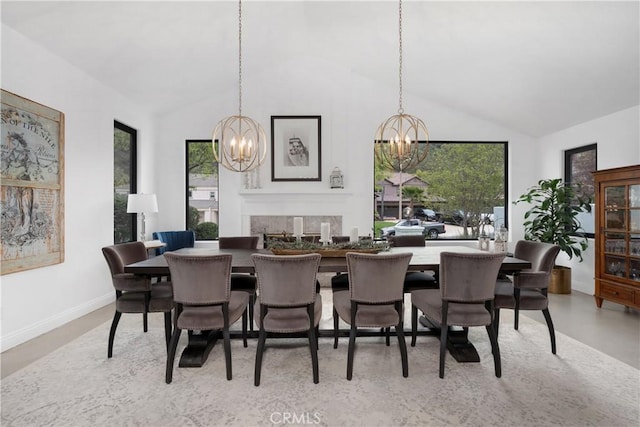 dining space with baseboards, high vaulted ceiling, and an inviting chandelier