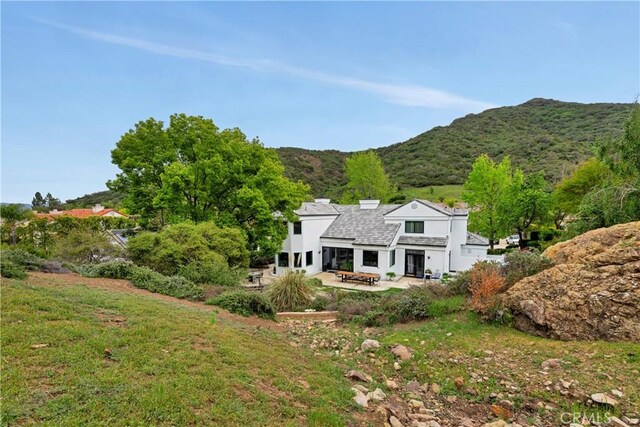 rear view of house featuring a patio and a mountain view