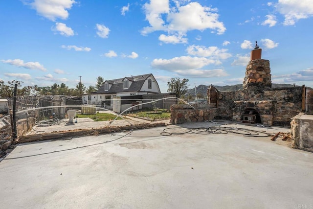 37650 Tripp Flats Rd, Anza, CA 92539 - view of patio featuring an outdoor stone fireplace and fence
