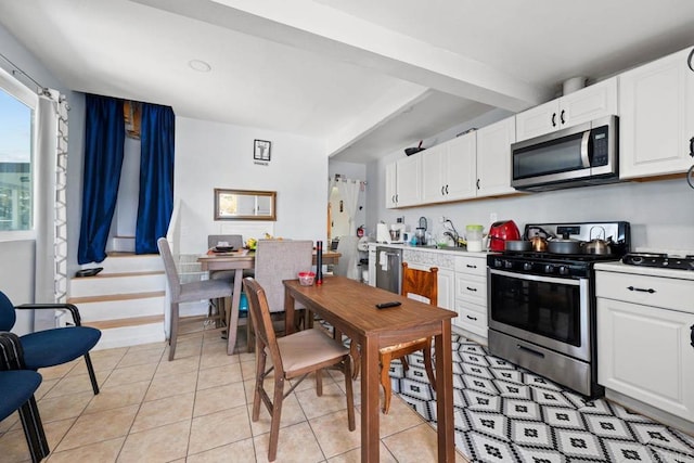 37650 Tripp Flats Rd, Anza, CA 92539 - kitchen with white cabinets, light tile patterned flooring, stainless steel appliances, and light countertops
