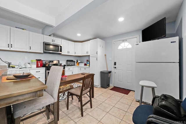 37650 Tripp Flats Rd, Anza, CA 92539 - kitchen featuring white cabinets, light countertops, beam ceiling, and appliances with stainless steel finishes