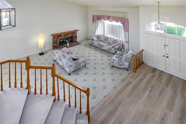 6721 Silver Oak Pl, Riverside, CA 92506 - living area with a fireplace, wood finished floors, and an inviting chandelier