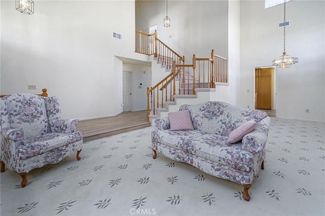 6721 Silver Oak Pl, Riverside, CA 92506 - living area with carpet floors, a high ceiling, stairs, and visible vents