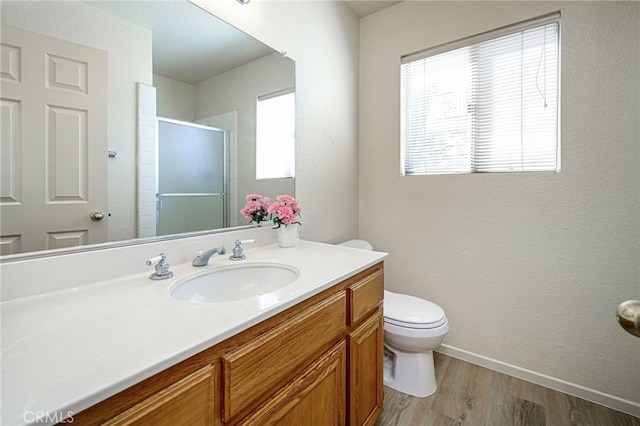 6721 Silver Oak Pl, Riverside, CA 92506 - bathroom featuring a shower stall, wood finished floors, toilet, vanity, and baseboards
