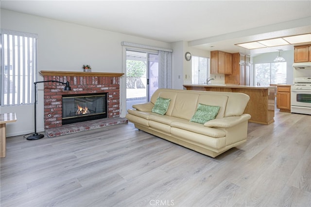 6721 Silver Oak Pl, Riverside, CA 92506 - living room featuring light wood-style floors and a brick fireplace