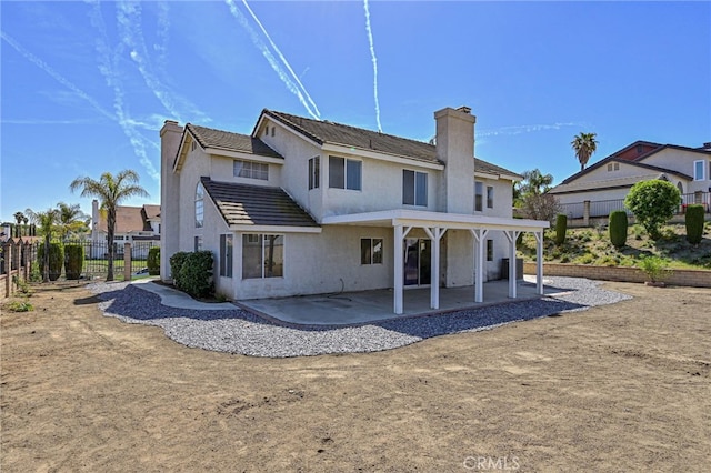 6721 Silver Oak Pl, Riverside, CA 92506 - rear view of property featuring fence, a chimney, and a patio