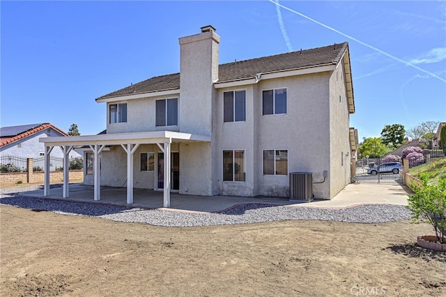 6721 Silver Oak Pl, Riverside, CA 92506 - back of house featuring a patio area, a chimney, fence, cooling unit, and stucco siding