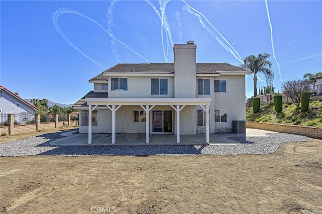 6721 Silver Oak Pl, Riverside, CA 92506 - rear view of house featuring a chimney, central air condition unit, a patio area, and stucco siding