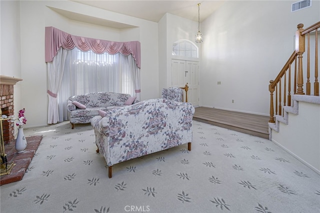 6721 Silver Oak Pl, Riverside, CA 92506 - carpeted living room with baseboards, visible vents, and stairway
