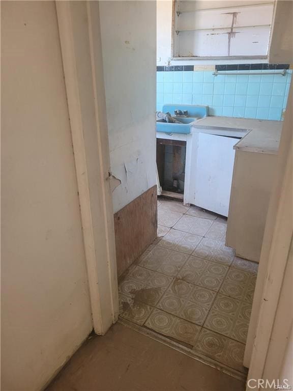 21284 Santa Fe Ave, Hinkley, CA 92347 - corridor with light tile patterned flooring and a sink