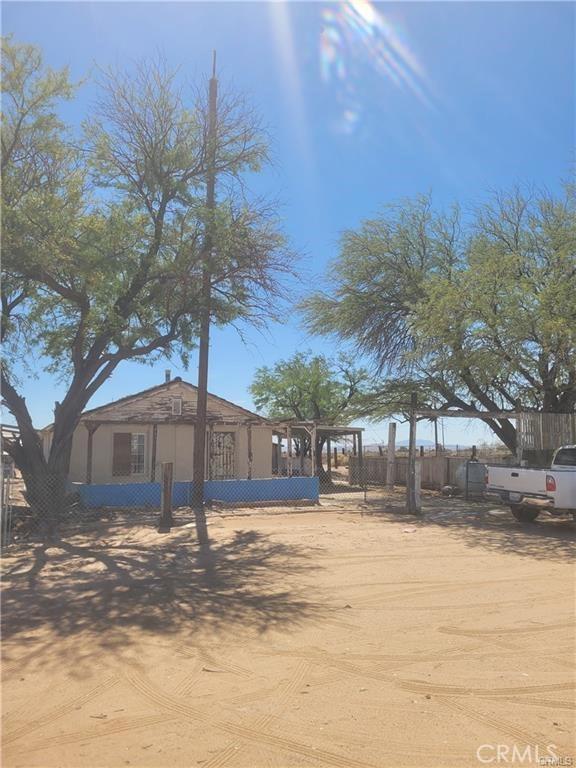 21284 Santa Fe Ave, Hinkley, CA 92347 - exterior space featuring stucco siding and fence