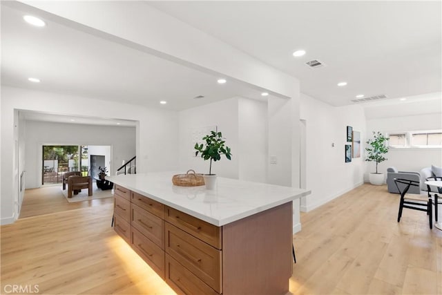 786 Carhart Ave, Fullerton, CA 92833 - kitchen with a center island, light wood-style floors, recessed lighting, a kitchen breakfast bar, and brown cabinets