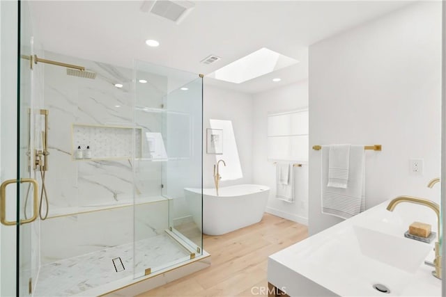 786 Carhart Ave, Fullerton, CA 92833 - full bathroom with a skylight, wood finished floors, a marble finish shower, a freestanding bath, and recessed lighting