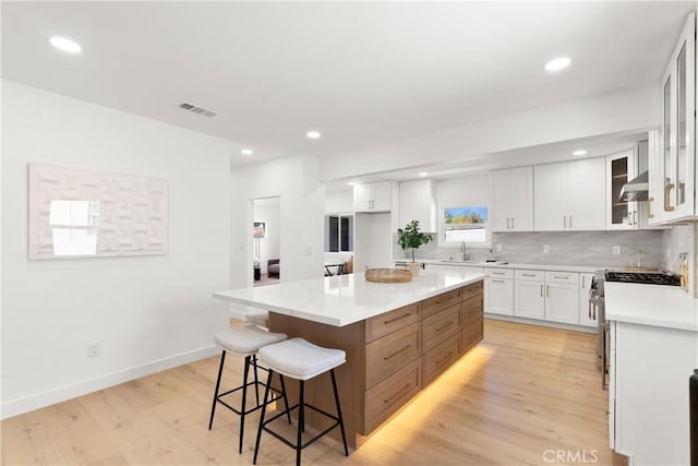 786 Carhart Ave, Fullerton, CA 92833 - kitchen with light wood-style floors, light countertops, white cabinets, decorative backsplash, and recessed lighting