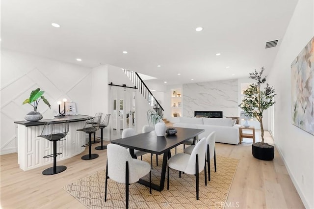 786 Carhart Ave, Fullerton, CA 92833 - dining space featuring a barn door, light wood-style floors, recessed lighting, and a fireplace