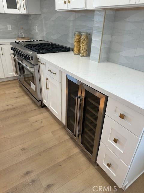 786 Carhart Ave, Fullerton, CA 92833 - kitchen with high end stove, wine cooler, light wood-type flooring, and white cabinets