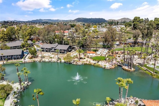 drone / aerial view featuring a water and mountain view and a residential view
