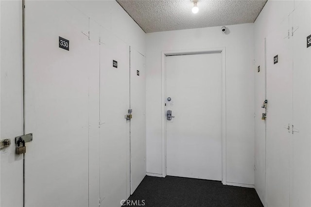 28691 Via Las Flores Unit 328, Murrieta, CA 92563 - hallway with a textured ceiling and dark carpet