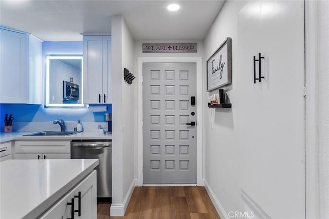28691 Via Las Flores Unit 328, Murrieta, CA 92563 - kitchen featuring appliances with stainless steel finishes, light countertops, dark wood-style flooring, and white cabinets
