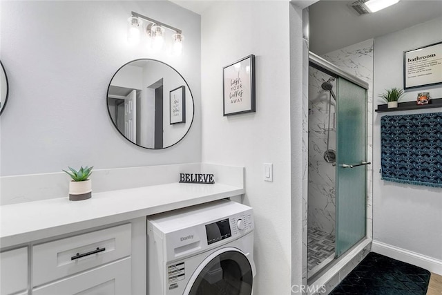 full bathroom with baseboards, a marble finish shower, and washer / clothes dryer