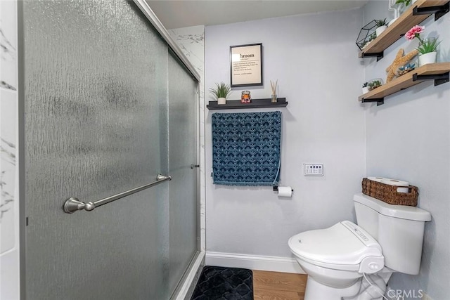 28691 Via Las Flores Unit 328, Murrieta, CA 92563 - bathroom featuring toilet, a stall shower, baseboards, and wood finished floors