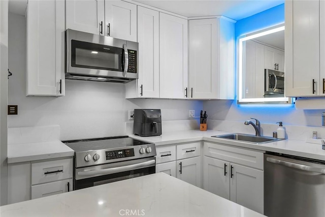 28691 Via Las Flores Unit 328, Murrieta, CA 92563 - kitchen with stainless steel appliances, a sink, and white cabinetry